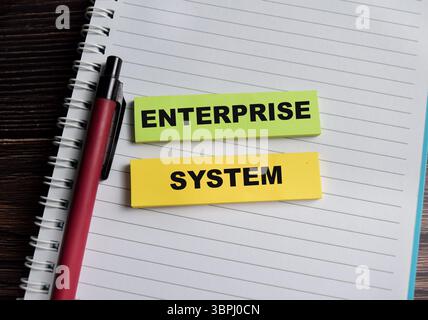 Concept of enterprise system write on sticky notes isolated on Wooden Table. Stock Photo
