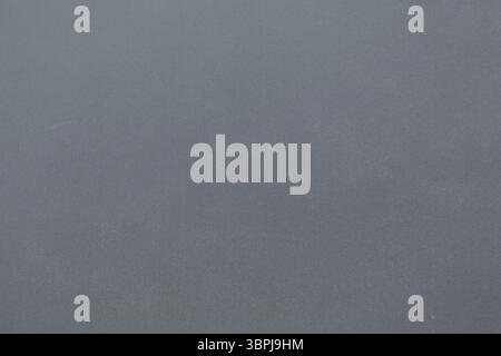 Flat design showing subtle speckled grey wall featuring gentle tonal variations, copy space Stock Photo