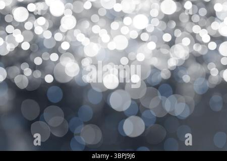 Abstract flat design showing defocused light spots creating bluish white bokeh pattern Stock Photo