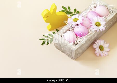 The minimum concept of Easter. Easter Eggs painted pink eggs on trendy pastel background. Copy space Stock Photo