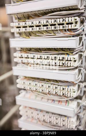 Flat design showing network punch-down panel featuring white terminal blocks with colorful wires Stock Photo