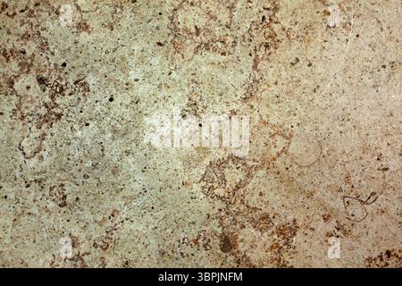 Showing rough beige and brown mottled stone surface in flat design, highlighting pits and speckles Stock Photo