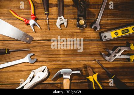 hand tools are being shown in flat design on wooden workbench with hammer, pliers, copy space Stock Photo