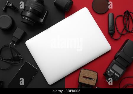 Composition with different gadgets and modern laptop on dark background Stock Photo