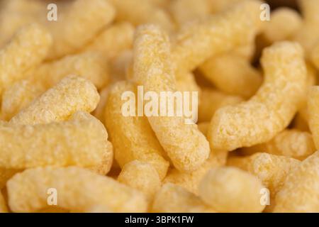 corn sticks from flour, a large number of corn sticks for eating or making breakfast with milk, corn sticks in a wooden bowl, close up Stock Photo