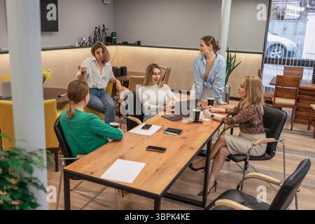 Teamwork meeting women, office, collaborate on project around table today, discussing business strategy. Stock Photo