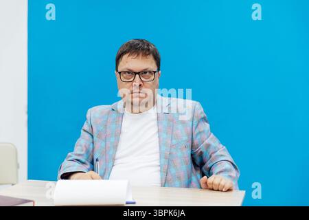 Business man in glasses working on laptop online in library office Stock Photo