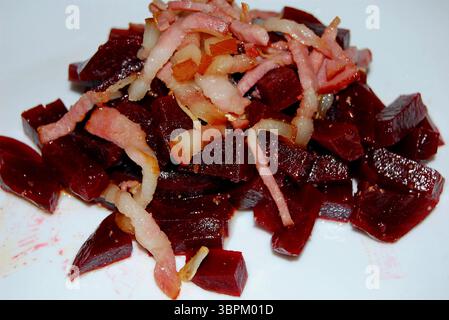 A beetroot salad with bacon and onion with sweet and sour reduction is a good choice for a quick summer meal Stock Photo