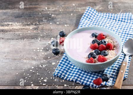 Healthy smoothie bowl with berries on wooden table Stock Photo
