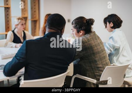 Business professionals brainstorming ideas collaboratively in a modern office space Stock Photo