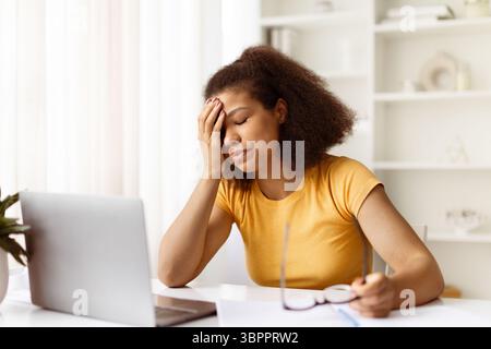 Exhausted black woman feeling tired during online work or study from home Stock Photo