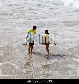 Man and woman seemingly having an argument or heated discussion on the shoreline, Fuerteventura, Canary Islands, Spain, Europe, EU Stock Photo