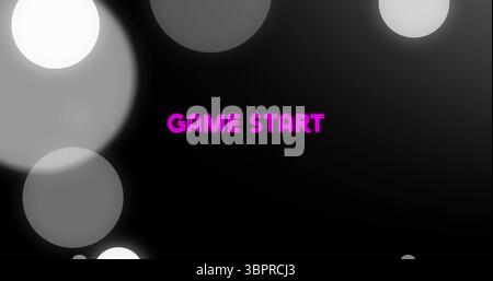 Displaying neon pink GAME START text glowing on digital display, featuring gray bokeh circles Stock Photo