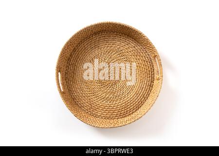 Wicker woven bamboo tray isolated on white background. Handmade by local craftsmen in sri lanka traditional tableware. View from above. Stock Photo