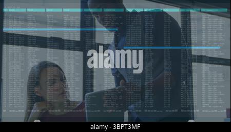 Collaborating office professionals analyzing data on transparent glass panel in meeting room Stock Photo