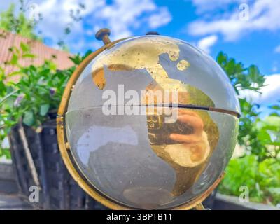 Old Globe with world map on blue sky background. Travel concept. High quality photo Stock Photo