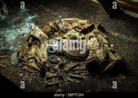 Cardboard box decaying with rusty metal parts in abandoned building, Indiana USA Stock Photo