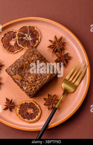 Chocolate brownie cake, food, sweet dessert with nuts rectangular shape. A slice of sweet chocolate brownie for the dinner table Stock Photo