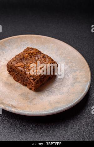 Chocolate brownie cake, food, sweet dessert with nuts rectangular shape. A slice of sweet chocolate brownie for the dinner table Stock Photo