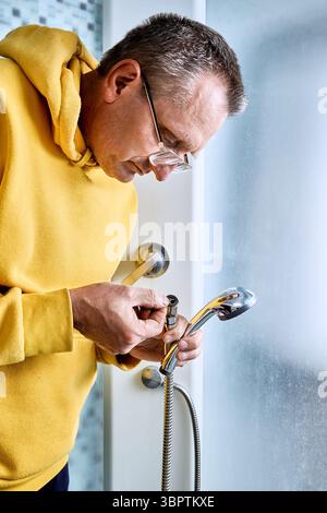 Preparing for hose replacement plumber checks sealing washer at end of