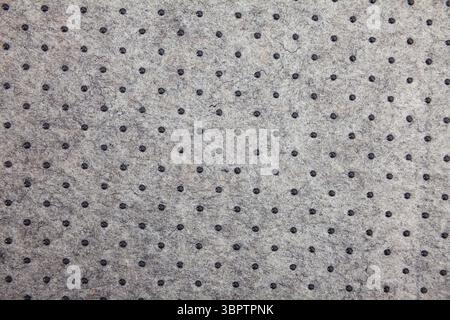 Grey felt material background with dark dots Stock Photo
