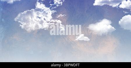 White cloud cluster is floating in soft blue sky with scattered wispy clouds, textured overlay Stock Photo