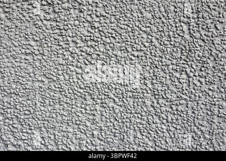 Rough stone stucco wall close-up abstract textured background Stock Photo