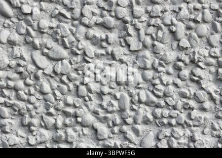 Concrete embedded with small stones close-up abstract textured background Stock Photo