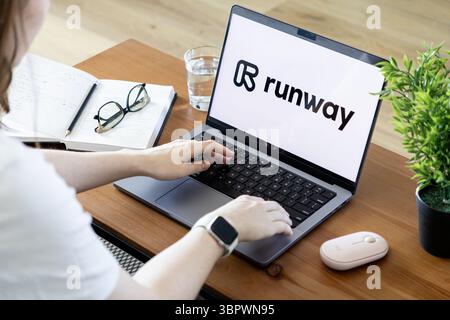 Poznan, Poland - June 15, 2025: Runway application displayed on laptop, showing person typing, demonstrating powerful AI for creative video generation Stock Photo