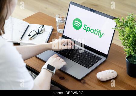 Poznan, Poland - June 15, 2025: Spotify application interface prominently featured on a laptop screen, used by an individual, symbolizing modern audio Stock Photo