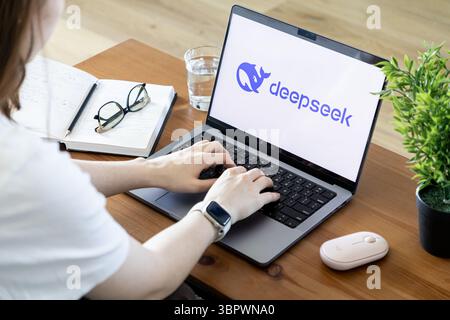 Poznan, Poland - June 15, 2025: Deepseek branding displayed on a modern laptop screen, with a person actively typing, illustrating innovative software Stock Photo