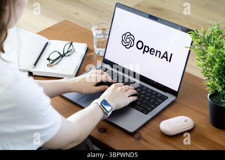 Poznan, Poland - June 15, 2025: OpenAI logo displayed on a modern laptop screen, with human hands typing, representing cutting-edge artificial intelli Stock Photo