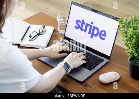 Poznan, Poland - June 15, 2025: Stripe's official application displayed on a bright laptop screen, person managing digital transactions and financial Stock Photo