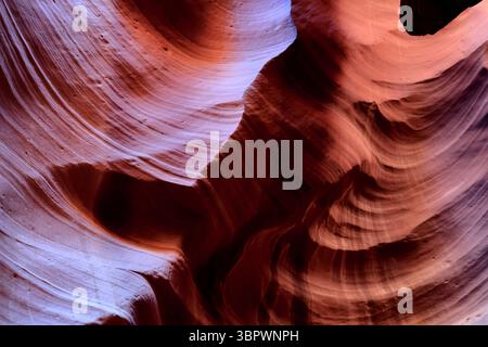 Ancient wind and water have sculpted Antelope Canyon's red and orange sandstone walls into sinuous waves that glow with warm desert hues forevermore! Stock Photo
