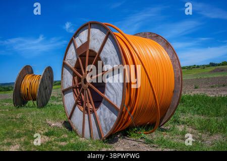Construction site with a fiber optic cable roll for digital broadband internet communication. Stock Photo
