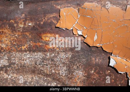 Rusty metal with cracked and peeled orange paint texture Stock Photo