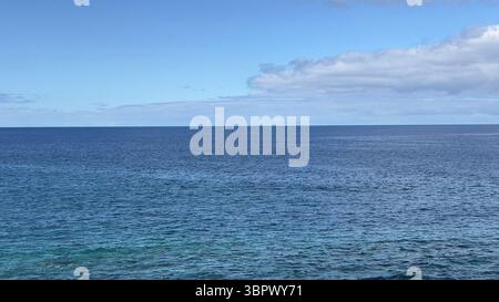 The endless atlantic ocean meets the clear blue sky in a beautiful landscape, Madeira ,Portugal Stock Photo