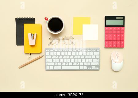 Composition with keyboard, coffee, calculator and notepad on beige background Stock Photo