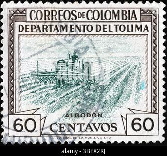 Farmer working in a field on stamp from Colombia Stock Photo