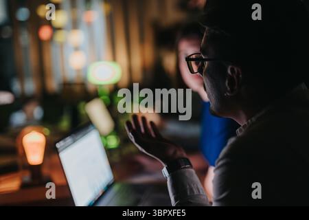 Multiracial team collaborating on project in office during late night hours Stock Photo
