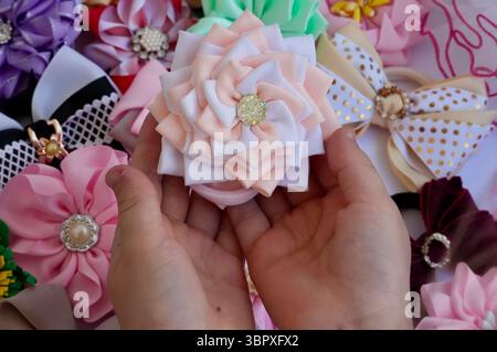 Hair ornament. Children's hands holding the ornament Stock Photo