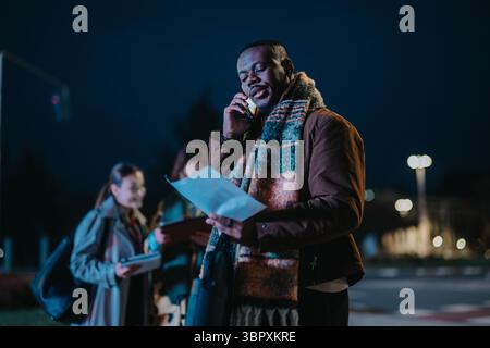 Multiracial people collaborating outside during the evening, embracing teamwork in a dynamic setting Stock Photo