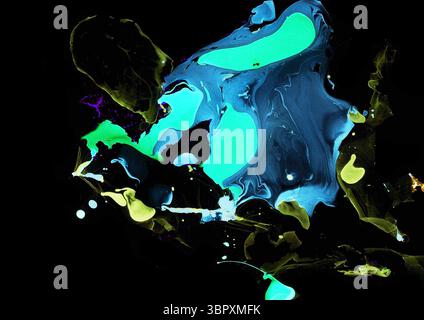 Abstract background consisting of chaotic spots of different colors and shades on black. Blue, yellow, olive green, turquoise colors. Marble effects, Stock Photo