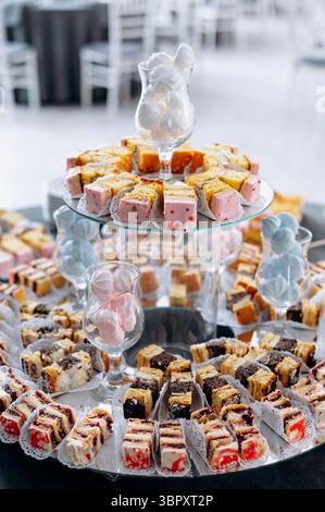 Candy bar with different tasty sweets and desserts on a wedding party Stock Photo