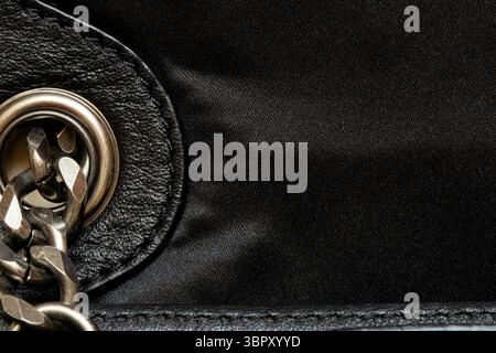 Black leather and fabric texture with metal chain - close up for background or template, women bag Stock Photo
