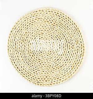 Top view of brown wicker table mat on white background. Straw round tray, flat lay, copy space. Stock Photo