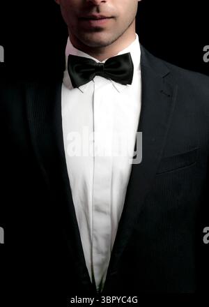 A man in a tuxedo with a bow tie. Stock Photo