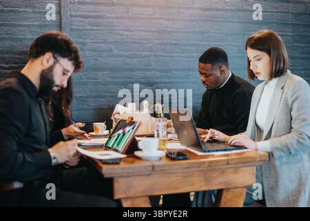 Group of professionals collaborating around a table in a business setting Stock Photo