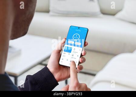 Smartphone interface for scheduling and timer control of smart devices in modern home Stock Photo