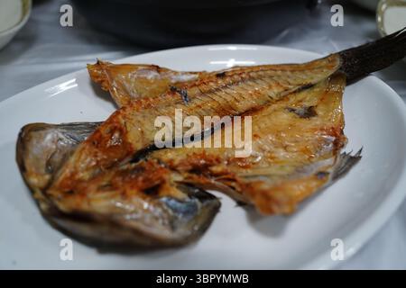 Grilled Mackerel Fish Served on White Plate in Restaurant Stock Photo